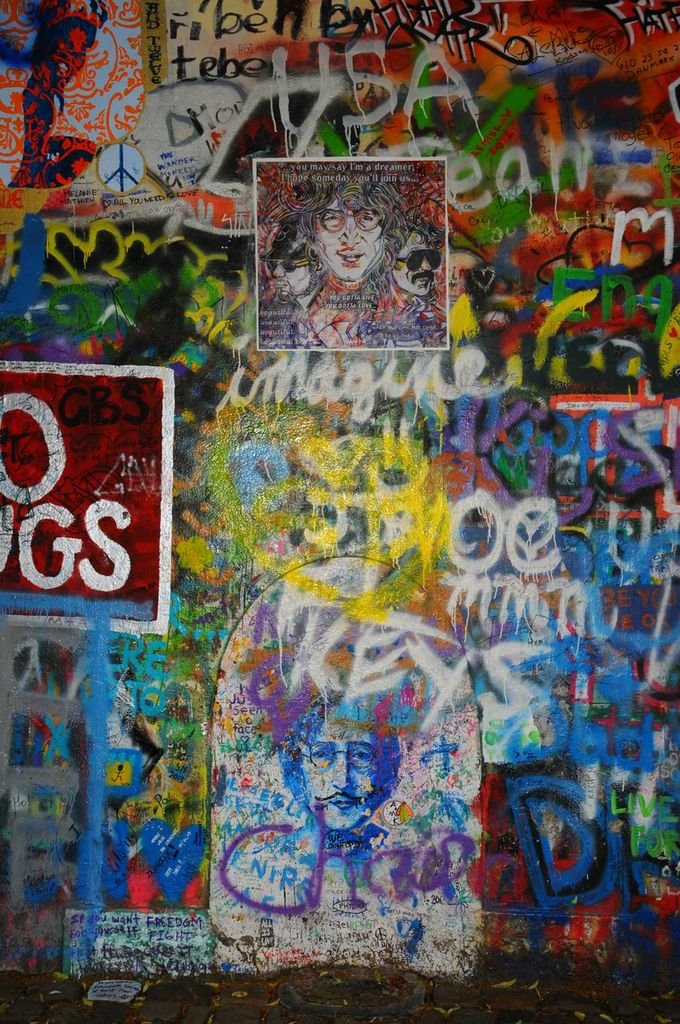 1M7AjgDjSfSmb9MWUTlg_CustomMade-painting-commemorating-lost-loved-ones-on-the-John-Lennon-wall-in-Prague.jpeg