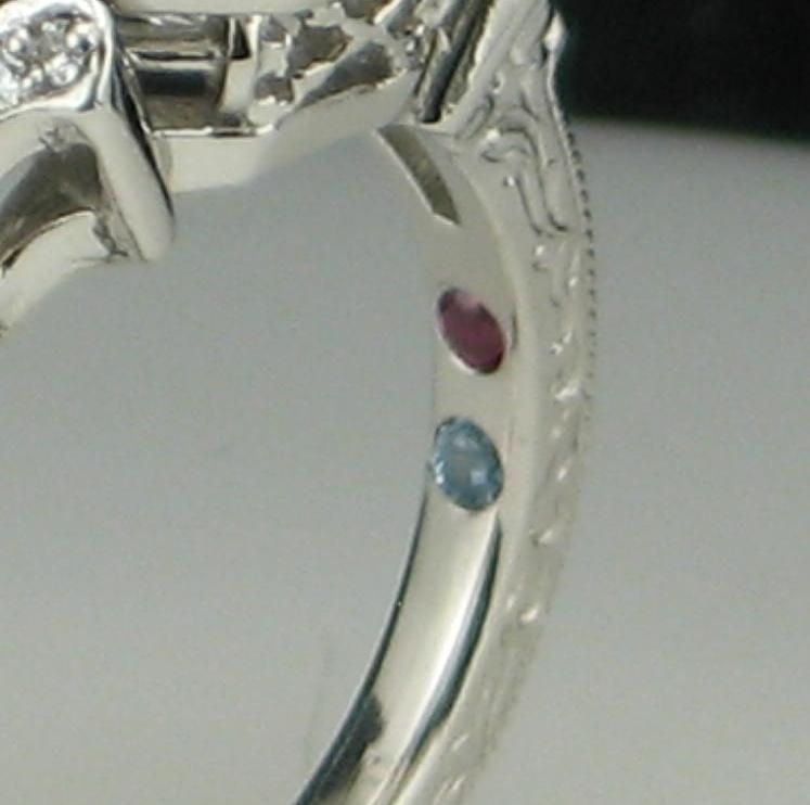 23rssd3YR92CzXClq7v4_Engagement-ring-with-birthstones-on-the-inner-band-via-CustomMade.jpeg
