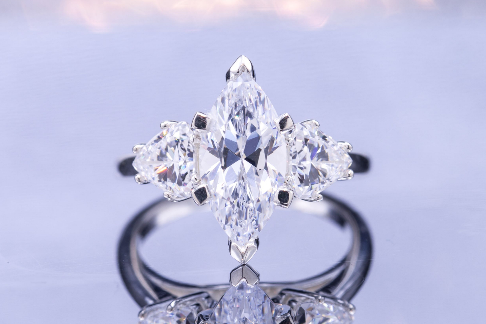 Three-stone cubic zirconia ring with marquise center stone and trillion cut side stones