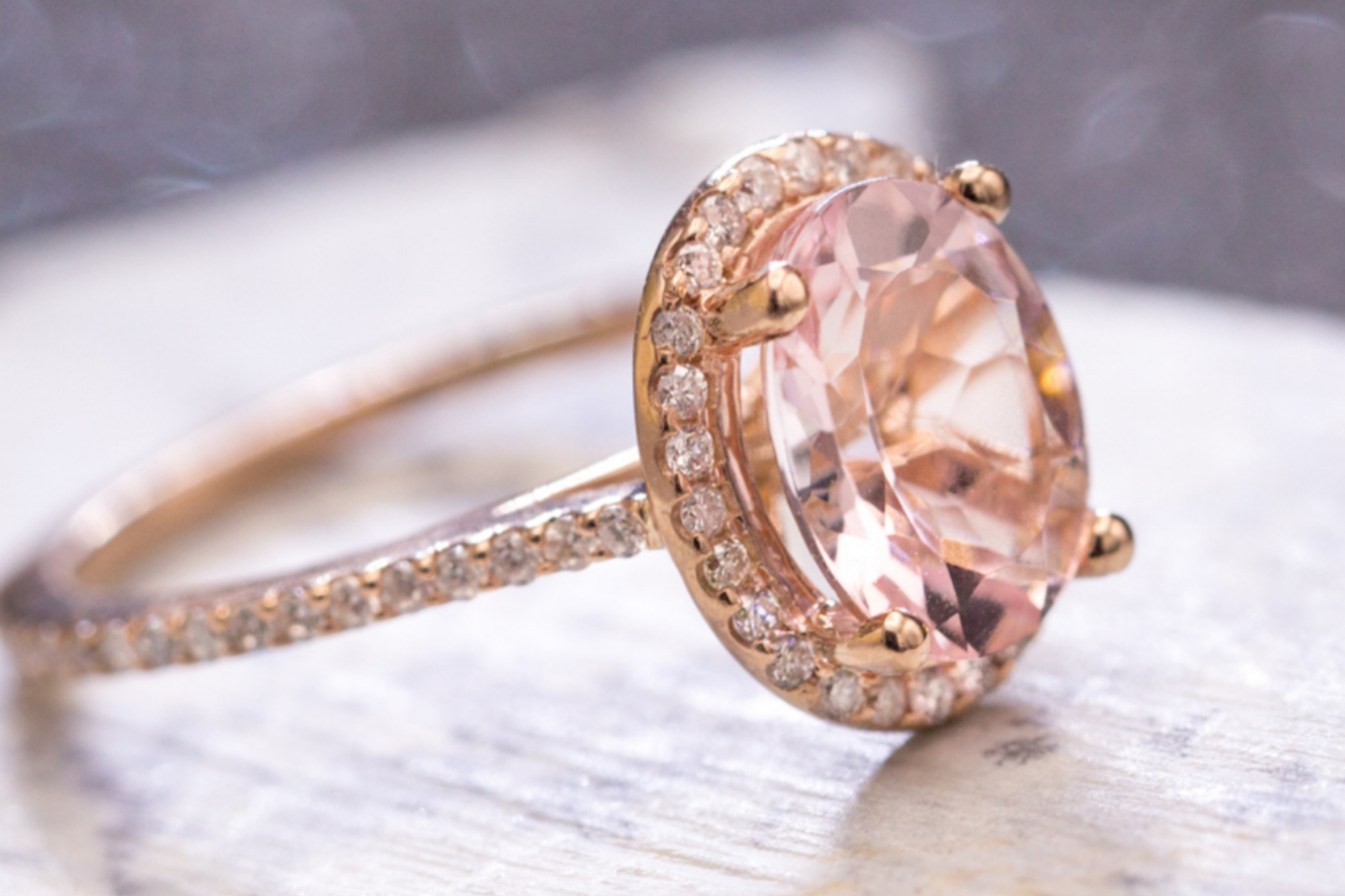 Rose gold halo engagement ring with oval cut morganite