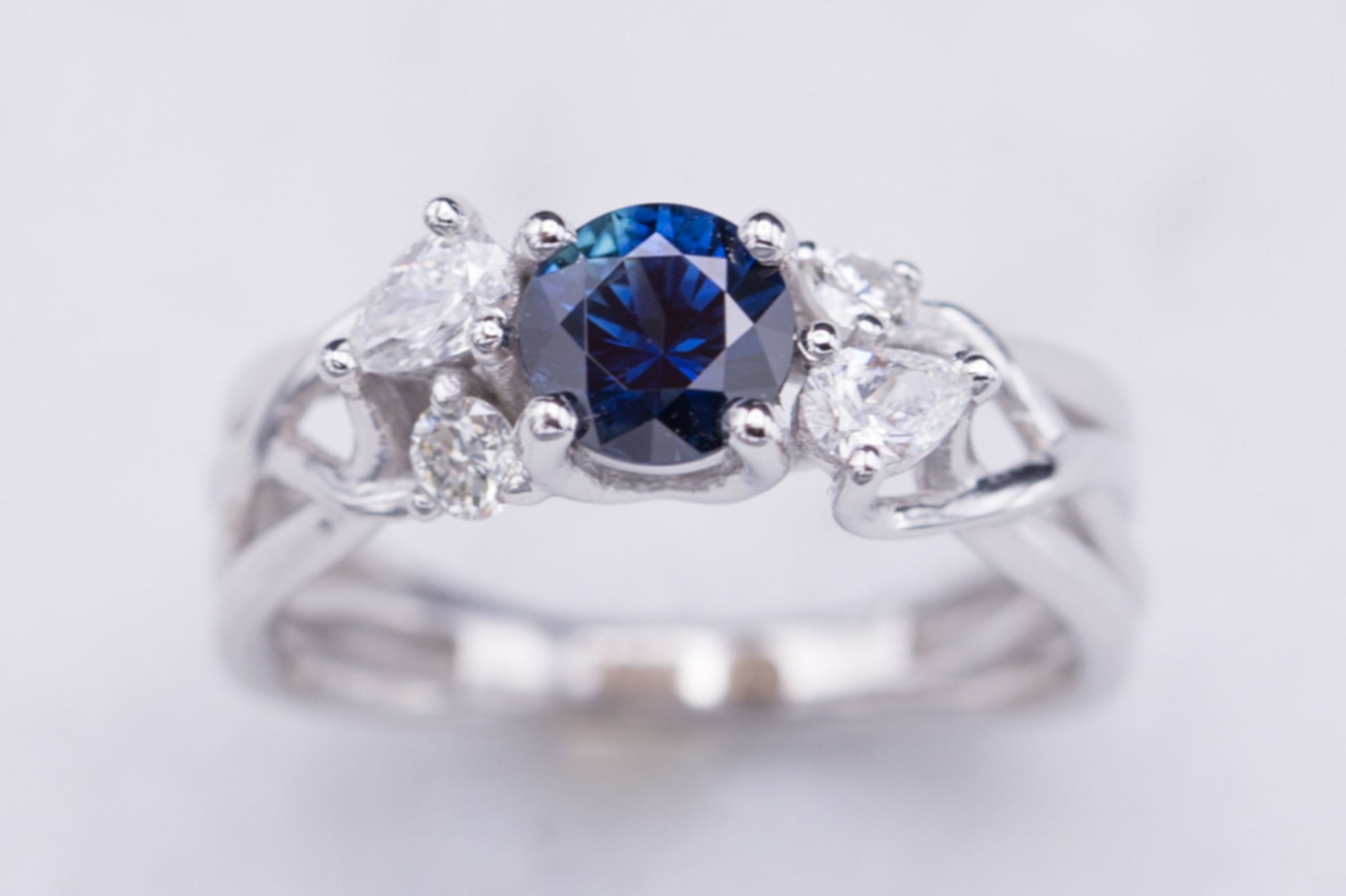 Sapphire and diamond engagement ring on delicate white gold strands